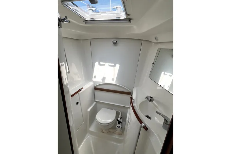 Slide: The Image of Bathroom interior of 2006 Beneteau Oceanis 393 yacht, featuring toilet, sink, and skylight. - 53