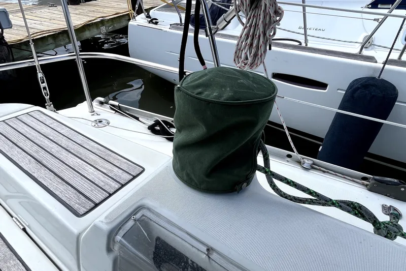 Slide: The Image of Deck of 2006 Beneteau Oceanis 393 sailboat with green cover and ropes. - 77