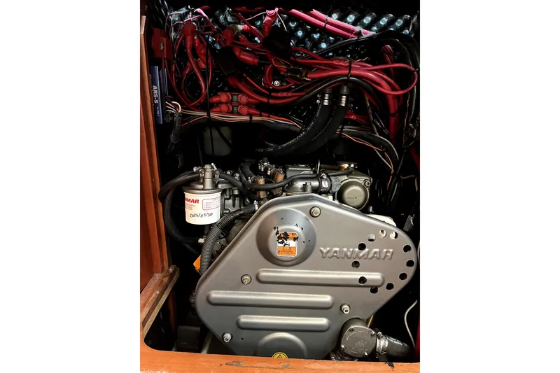 Slide: The Image of Yanmar engine in a 2006 Beneteau Oceanis 393 sailboat, showcasing detailed wiring and components. - 45