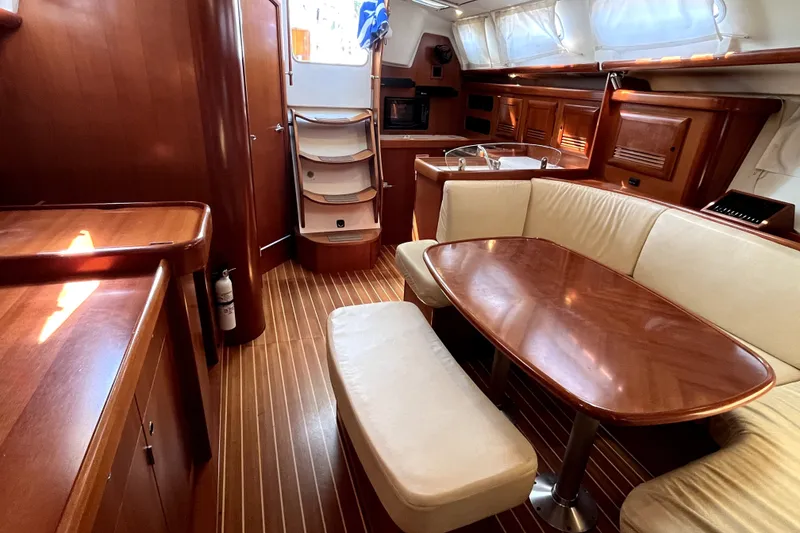 Slide: The Image of Interior of 2006 Beneteau Oceanis 393 yacht, featuring elegant wood finish and cozy seating area. - 15