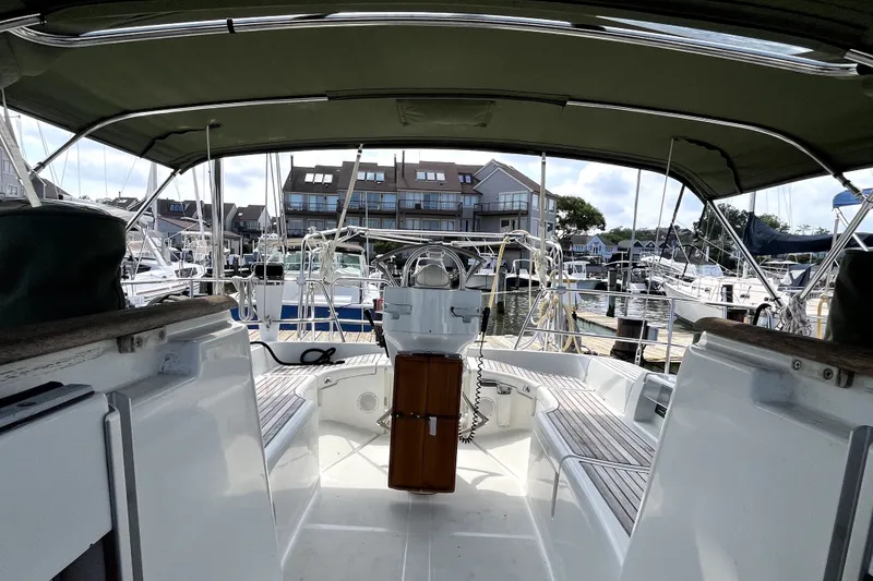 Slide: The Image of Cockpit view of a 2006 Beneteau Oceanis 393 sailboat docked at a marina. - 57
