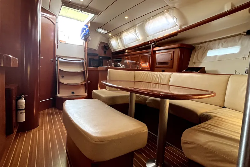 Slide: The Image of Interior of 2006 Beneteau Oceanis 393 yacht with elegant wood finish and cozy seating. - 14