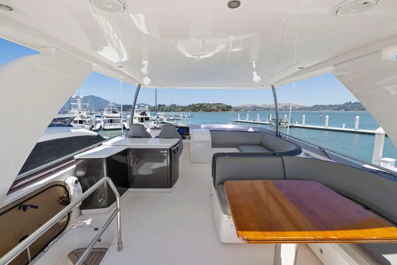 Slide: The Image of Luxurious 2015 Princess 60 Flybridge Motor Yacht with spacious seating and scenic marina view. - 52