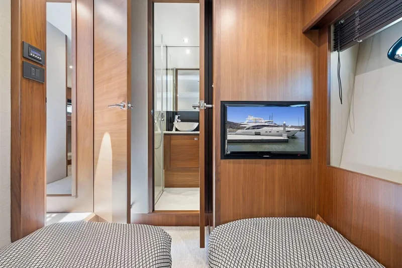 Slide: The Image of Interior of 2015 Princess 60 Flybridge Motor Yacht with modern wood paneling and TV display. - 46