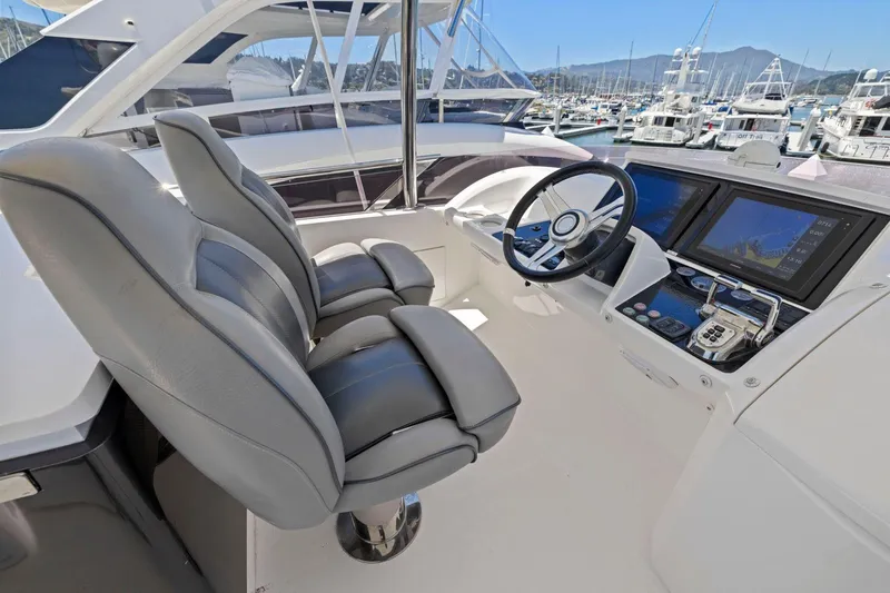 Slide: The Image of Helm of 2015 Princess 60 Flybridge Motor Yacht with dual seats and navigation screens. - 59