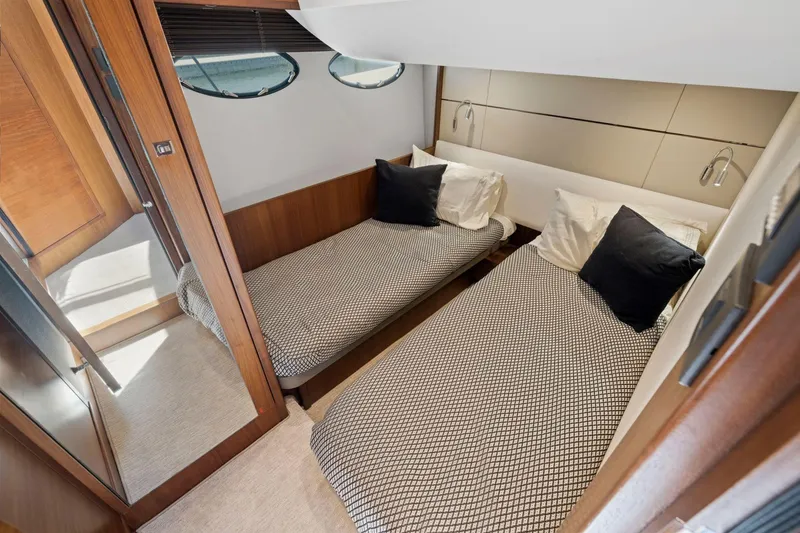 Slide: The Image of Twin cabin interior of 2015 Princess 60 Flybridge Motor Yacht, featuring modern design and cozy bedding. - 44