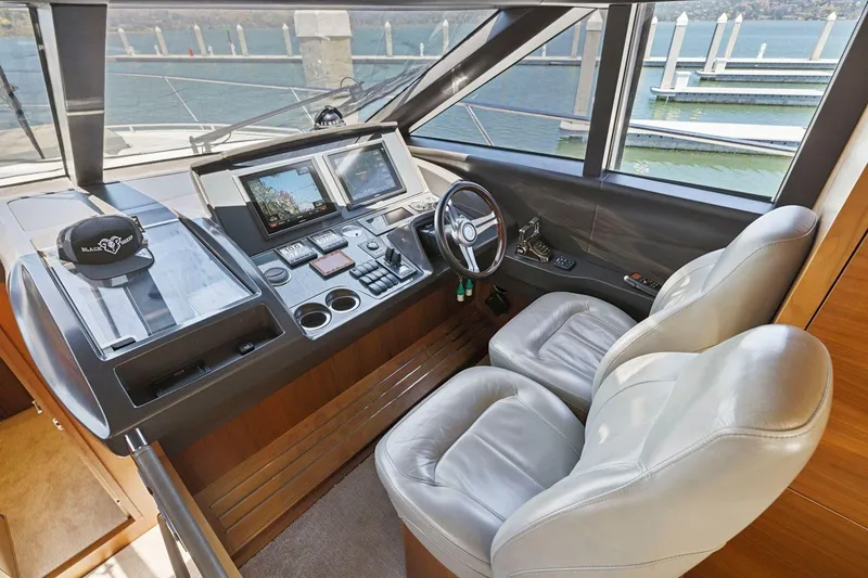 Slide: The Image of Helm of 2015 Princess 60 Flybridge Motor Yacht with dual seats and navigation controls. - 27