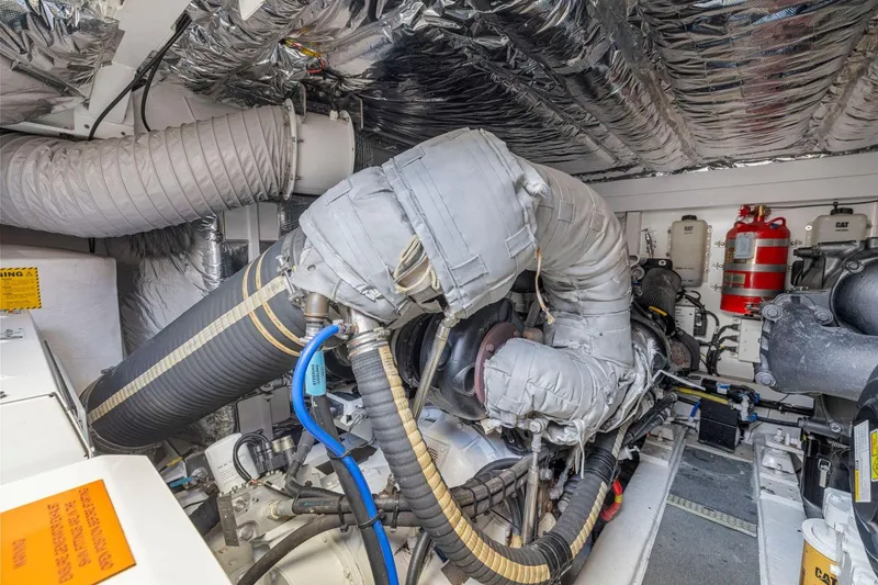 Slide: The Image of Engine room of a 2015 Princess 60 Flybridge Motor Yacht, showcasing insulated components and equipment. - 64
