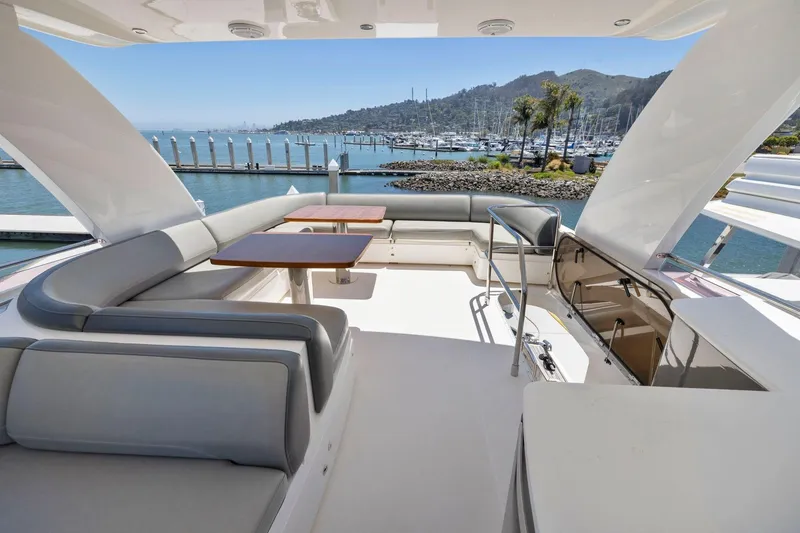 Slide: The Image of Luxurious 2015 Princess 60 Flybridge Motor Yacht with spacious seating and scenic marina view. - 53