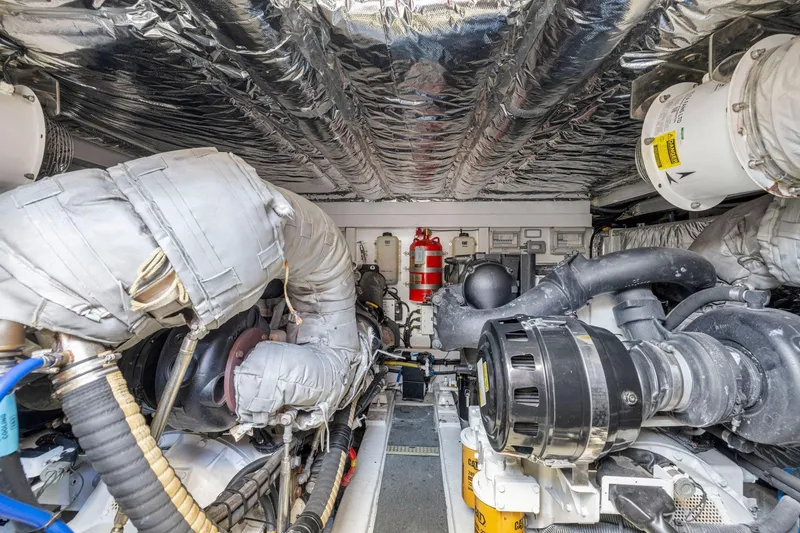 Slide: The Image of Engine room of 2015 Princess 60 Flybridge Motor Yacht, showcasing complex machinery and insulation. - 62