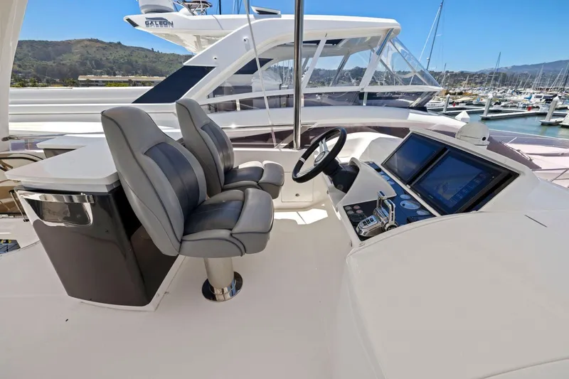 Slide: The Image of Flybridge helm of 2015 Princess 60 Motor Yacht with dual seats and navigation screens. - 58