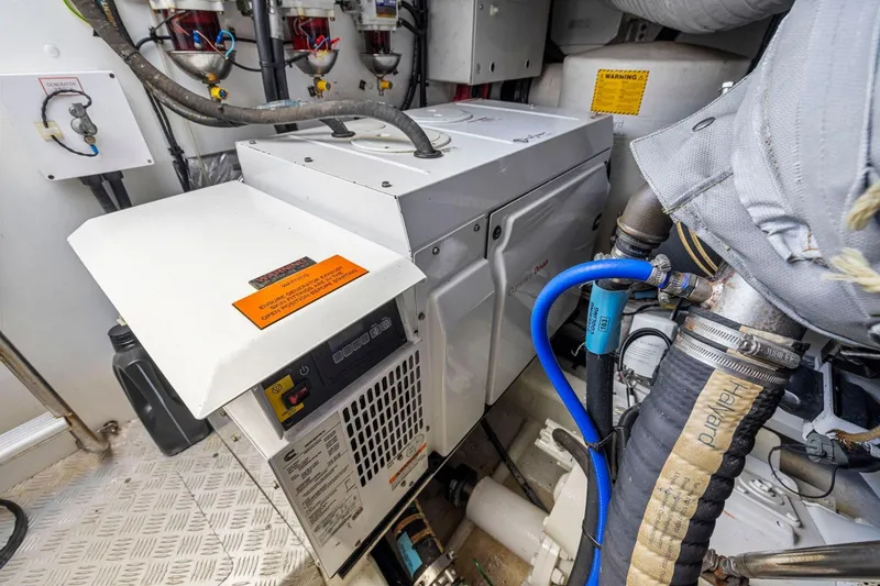 Slide: The Image of Engine room of 2015 Princess 60 Flybridge Motor Yacht, featuring generator and hoses. - 65