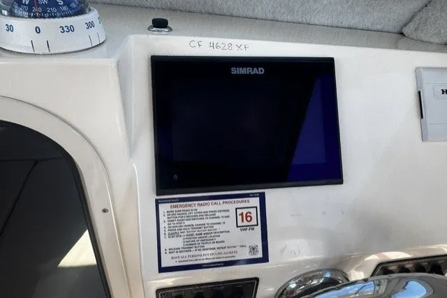 Slide: The Image of Dashboard of 2022 Defiance Admiral 250 EX with Simrad display and emergency procedures. - 14