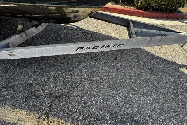 Slide: The Image of Boat trailer labeled "Pacific" on asphalt, for 2022 Defiance Admiral 250 EX. - 18