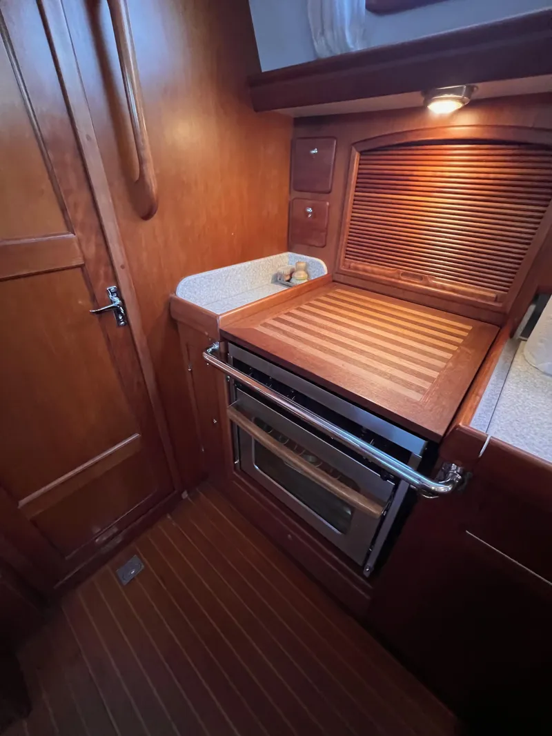 Slide: The Image of Wooden kitchen interior of 2008 Outbound 46 yacht with stove and storage. - 40