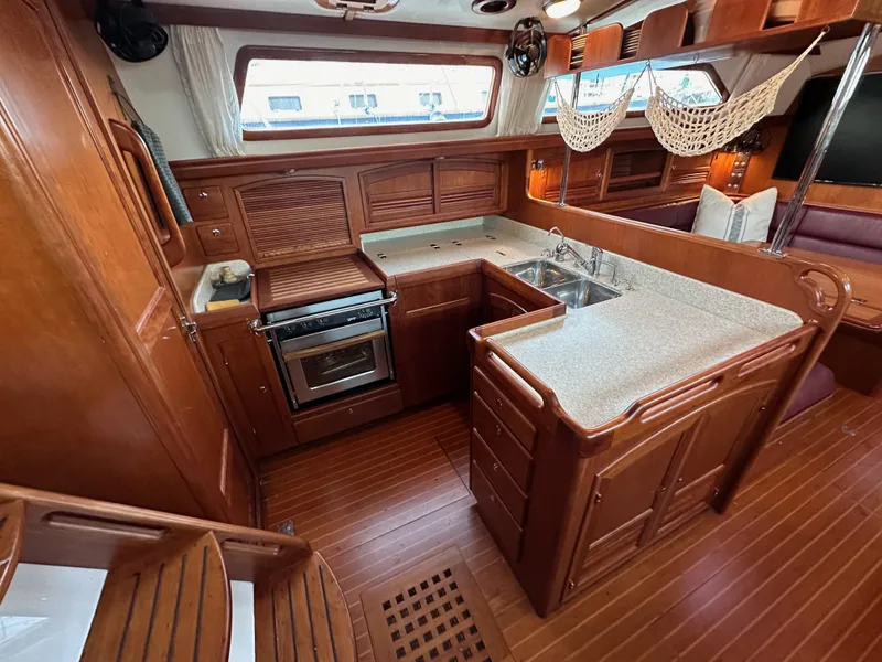 Slide: The Image of Luxurious 2008 Outbound 46 yacht interior with wooden cabinetry and modern kitchen amenities. - 38