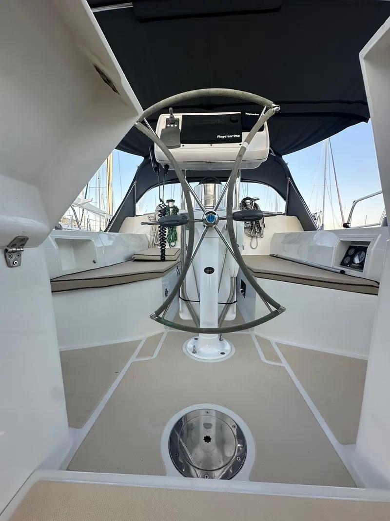 Slide: The Image of Outbound 46 sailboat cockpit, 2008 model, featuring a sleek steering wheel and spacious seating. - 26