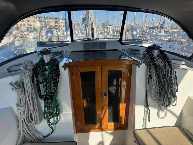 Slide: The Image of Cockpit of 2008 Outbound 46 sailboat with ropes and wooden cabinet. - 24