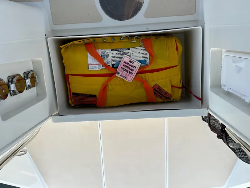 Slide: The Image of Safety equipment storage on 2008 Outbound 46 yacht, featuring a yellow emergency pack. - 31
