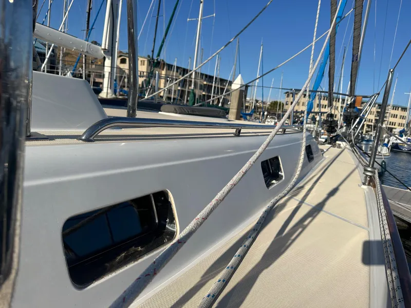 Slide: The Image of Sailboat deck view of 2008 Outbound 46 in marina, showcasing sleek design and rigging. - 21