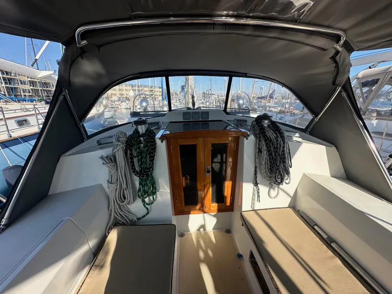 Slide: The Image of Cockpit of 2008 Outbound 46 sailboat with ropes and seating, docked at marina. - 19