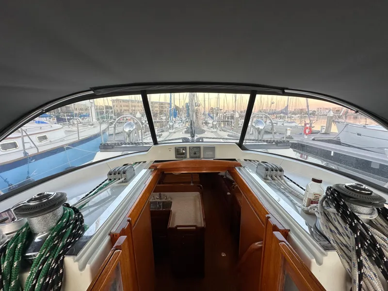 Slide: The Image of Interior view of 2008 Outbound 46 sailboat cockpit with marina background. - 36