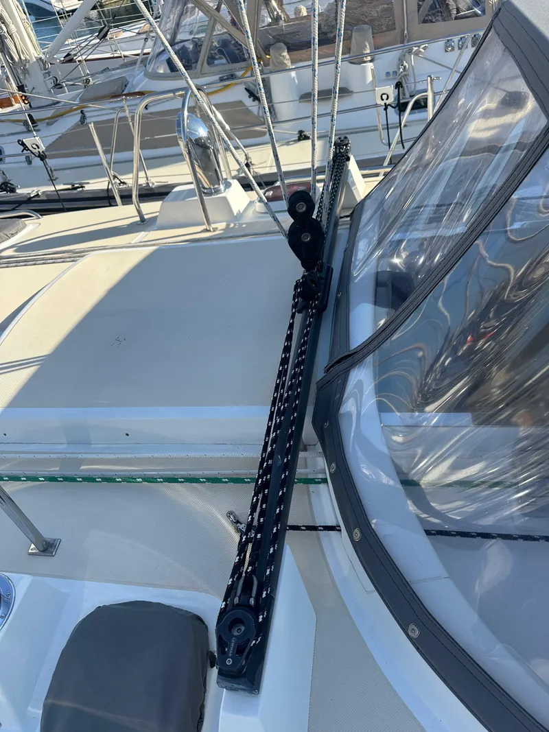 Slide: The Image of Sailboat deck with rigging, Outbound 46, 2008 model, featuring clear canopy and winch system. - 14