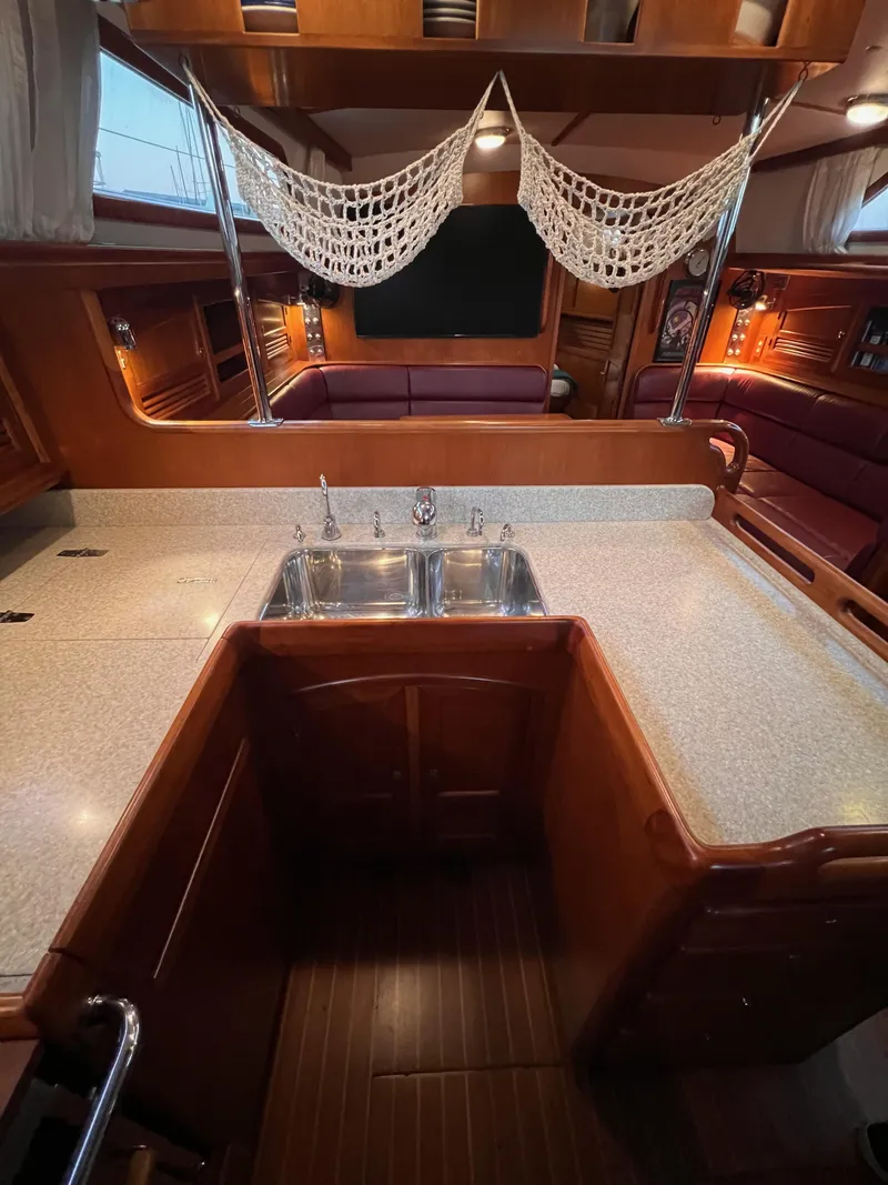Slide: The Image of Luxurious 2008 Outbound 46 yacht interior with spacious kitchen and elegant wood finish. - 42