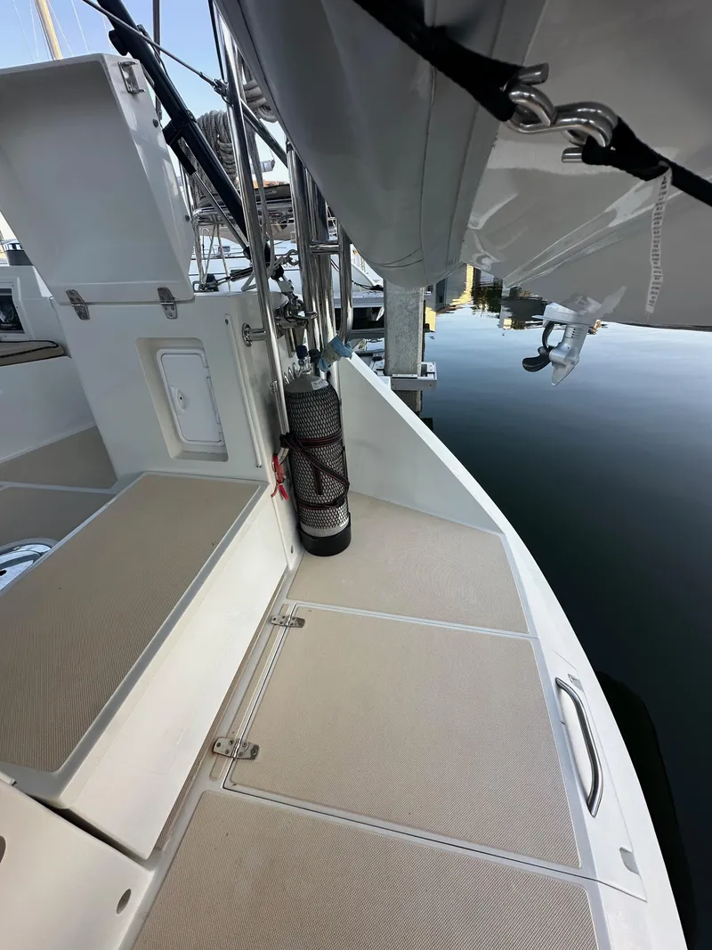 Slide: The Image of 2008 Outbound 46 sailboat deck with storage compartments and dock view. - 33