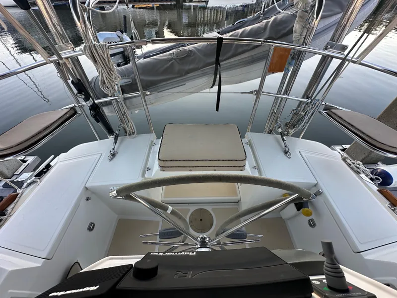 Slide: The Image of Cockpit view of a 2008 Outbound 46 sailboat, featuring steering wheel and controls. - 27