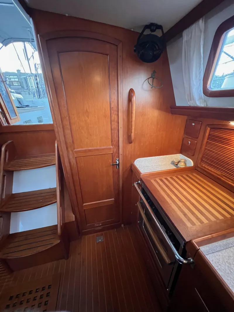 Slide: The Image of Interior of 2008 Outbound 46 yacht with wooden cabinetry and compact kitchen area. - 39