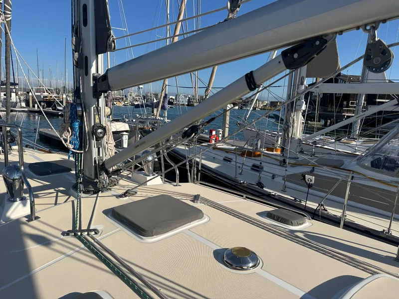 Slide: The Image of Sailboat deck view of 2008 Outbound 46 at marina, featuring rigging and hatches. - 18