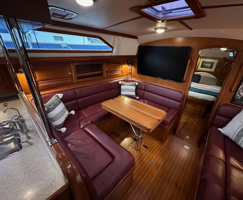 Slide: The Image of Luxurious 2008 Outbound 46 yacht interior with leather seating, dining table, and modern amenities. - 47