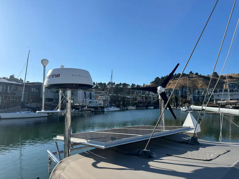 Slide: The Image of Sailboat docked in marina, featuring solar panels and radar equipment, Outbound 46, 2008 model. - 34