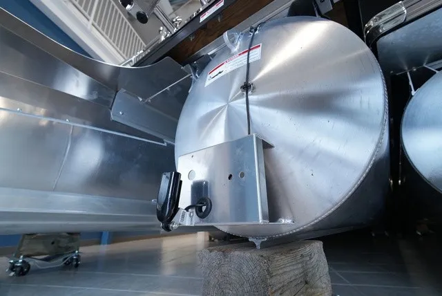Slide: The Image of Close-up of a silver pontoon of a Barletta Sanza 22 UC boat resting on a wooden block. - 30