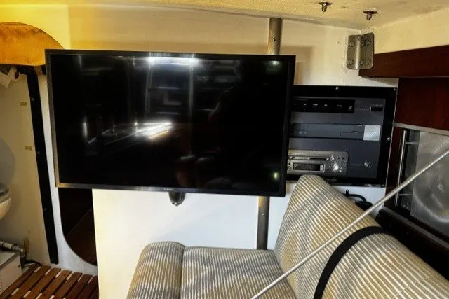 Slide: The Image of Interior of 1973 Custom BILL LEE 40 yacht with TV and striped seating. - 23