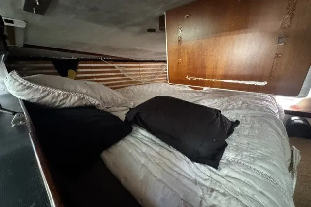 Slide: The Image of Cozy cabin interior of 1973 Custom BILL LEE 40 sailboat with bedding and wooden paneling. - 22