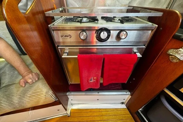 Slide: The Image of Vintage 1973 Custom BILL LEE 40 yacht stove with red towels in cozy cabin setting. - 30