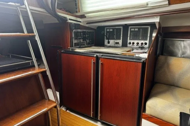 Slide: The Image of Interior of a 1973 Custom BILL LEE 40 yacht with wooden cabinetry and navigation equipment. - 32