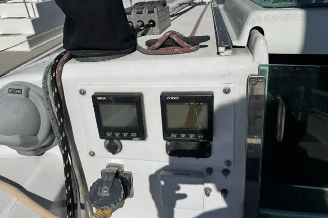 Slide: The Image of Cockpit instruments on a 1973 Custom BILL LEE 40 sailboat, featuring wind and sea data displays. - 16