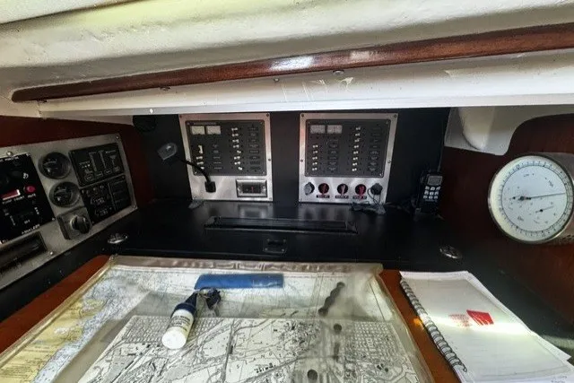 Slide: The Image of Navigation station of a 1973 Custom BILL LEE 40 sailboat with charts and instruments. - 34