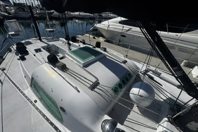 Slide: The Image of Sailboat docked in marina, Custom BILL LEE 40, 1973 model, with visible deck and rigging. - 5