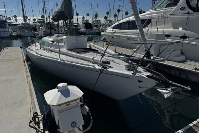 Slide: The Image of Sailboat docked in marina, 1973 Custom BILL LEE 40, surrounded by other boats. - 1