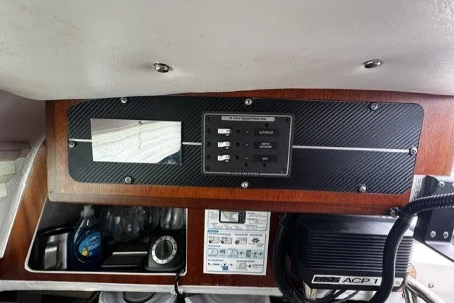 Slide: The Image of Control panel inside a 1973 Custom BILL LEE 40 yacht, featuring switches and storage compartments. - 38