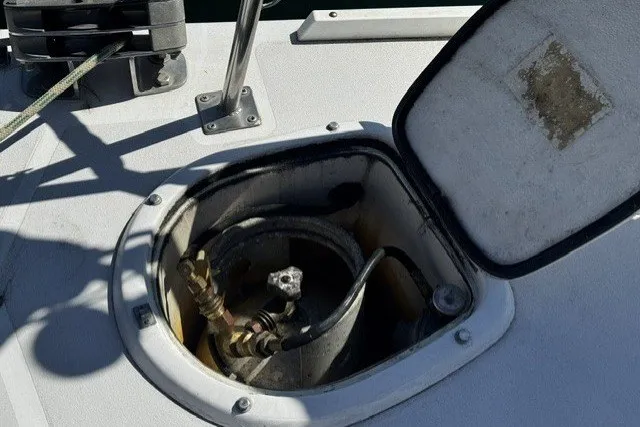 Slide: The Image of Open hatch on 1973 Custom BILL LEE 40 sailboat deck, revealing internal components. - 11