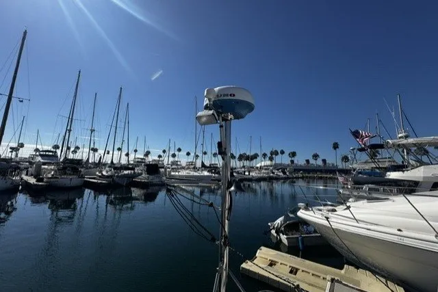 Slide: The Image of Marina with sailboats and yachts under clear blue sky, featuring a 1973 Custom BILL LEE 40. - 13