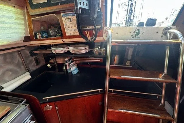 Slide: The Image of Interior of a 1973 Custom BILL LEE 40 yacht with kitchen and wooden stairs. - 29