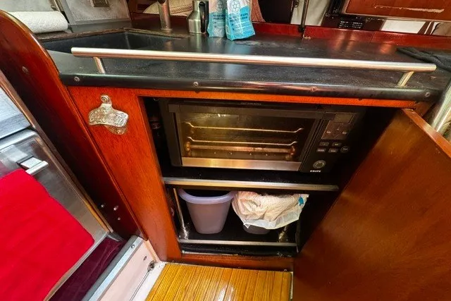 Slide: The Image of Kitchen area of a 1973 Custom BILL LEE 40 yacht with a built-in oven. - 31
