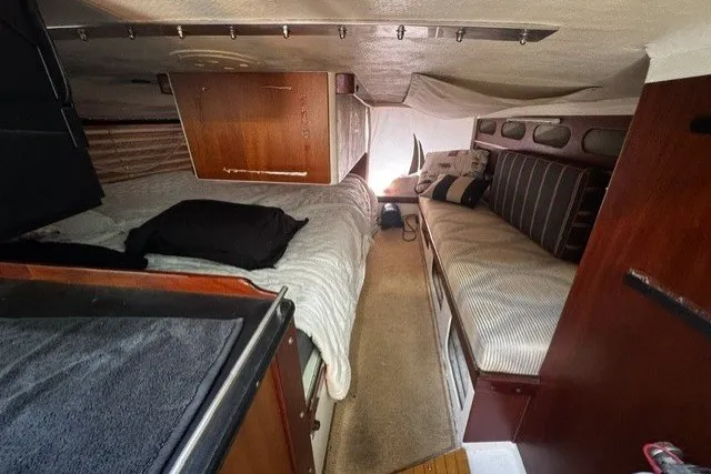 Slide: The Image of Interior of a 1973 Custom BILL LEE 40 sailboat with cozy sleeping area and wooden accents. - 21