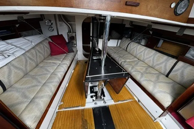 Slide: The Image of Interior of 1973 Custom BILL LEE 40 sailboat with cozy seating and wooden flooring. - 20